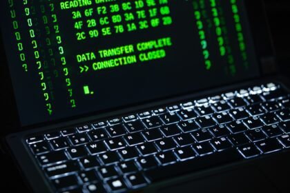 Close-up of a laptop screen displaying green code text. Perfect for cybersecurity themes.